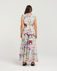 Woman wearing a long dress with a colorful pattern on a white background