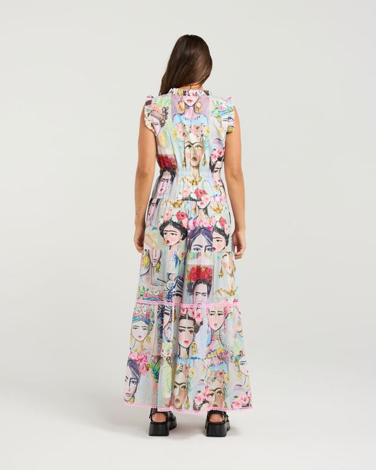 Woman wearing a long dress with a colorful pattern on a white background