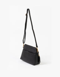 Black handbag with a strap on a white background