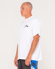 Man wearing a white t-shirt with a logo on a plain background
