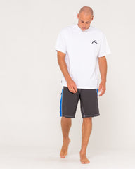 Man wearing a white t-shirt and gray shorts with blue accents on a white background
