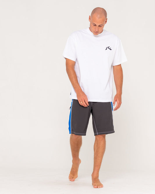 Man wearing a white t-shirt and gray shorts with blue accents on a white background