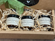 Three small jars of candles in a decorative box with a green ribbon, featuring 'Crafty Chook Candles' branding.