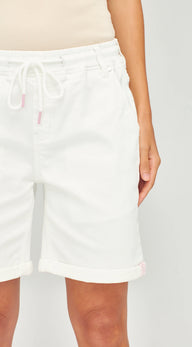 White drawstring shorts with rolled cuffs, shown on a model against a light gray background.