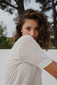 short-sleeve cream-colored knit sweater