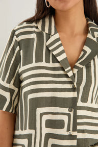 Person wearing a patterned shirt with geometric design