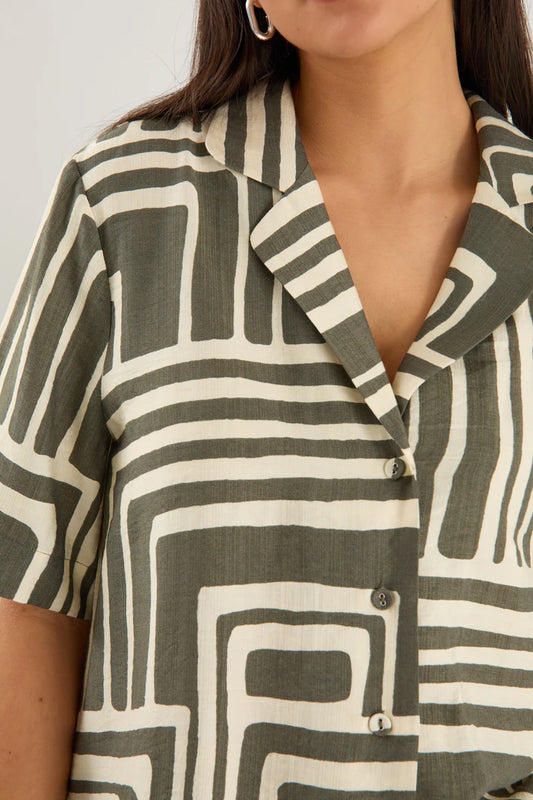 Person wearing a patterned shirt with geometric design