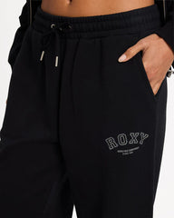 Black sweatpants with 'ROXY' branding on a plain background