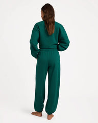 Person wearing a green tracksuit on a white background