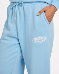 Light blue sweatpants with a brand logo on a light gray background