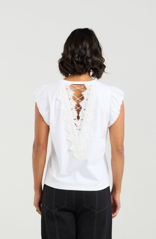 Person wearing a white top and black pants on a plain background