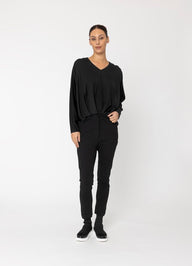 Person wearing a black outfit on a white background