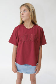 Person wearing a red t-shirt with text on a white background