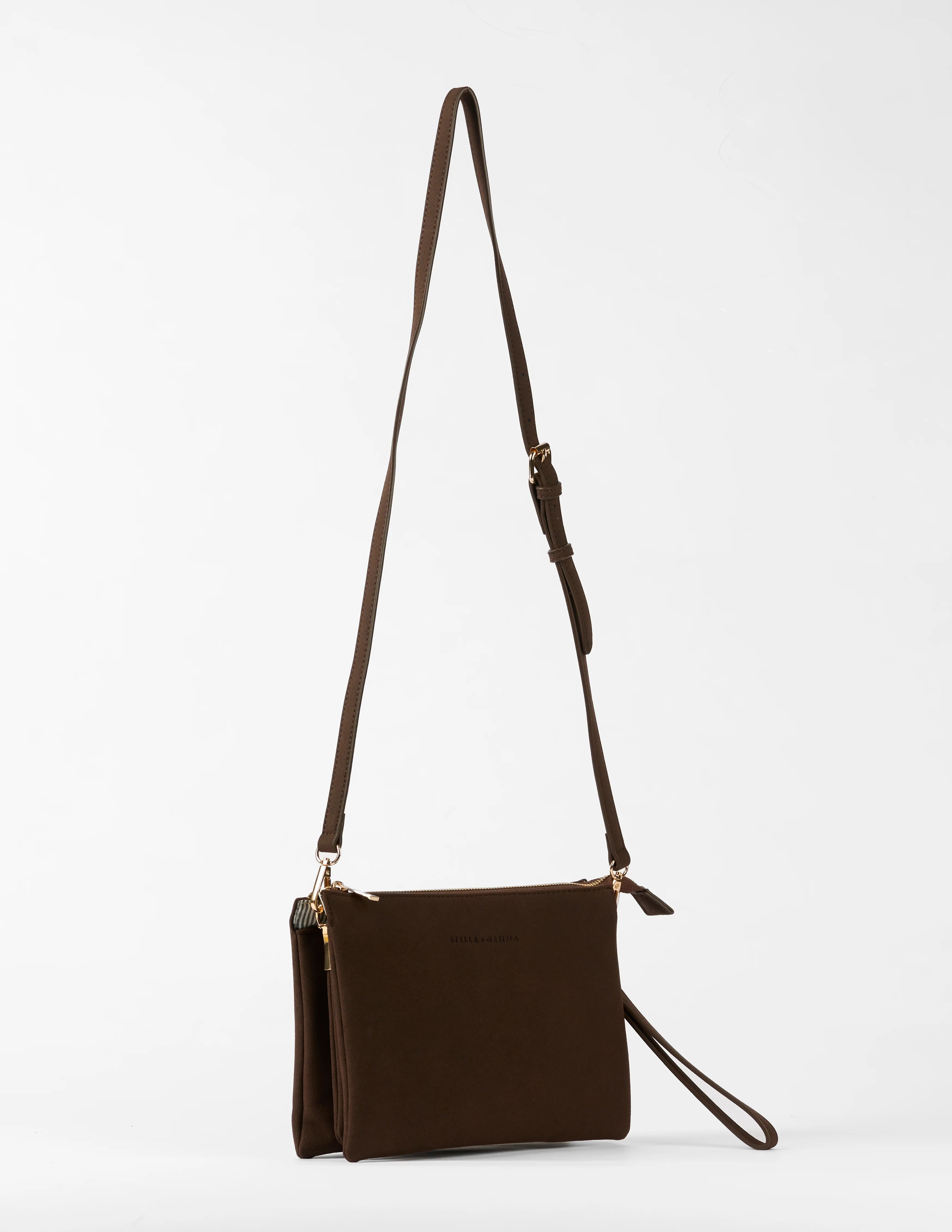 Brown leather crossbody bag with a strap on a white background