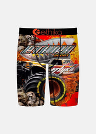 Boxer briefs with a graphic design of a skull, monster truck, and tire on a red background.
