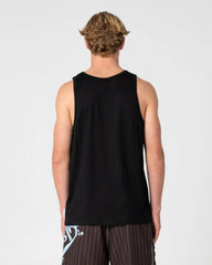 A man viewed from behind wearing a black sleeveless tank top and dark pinstriped shorts against a light gray studio background.