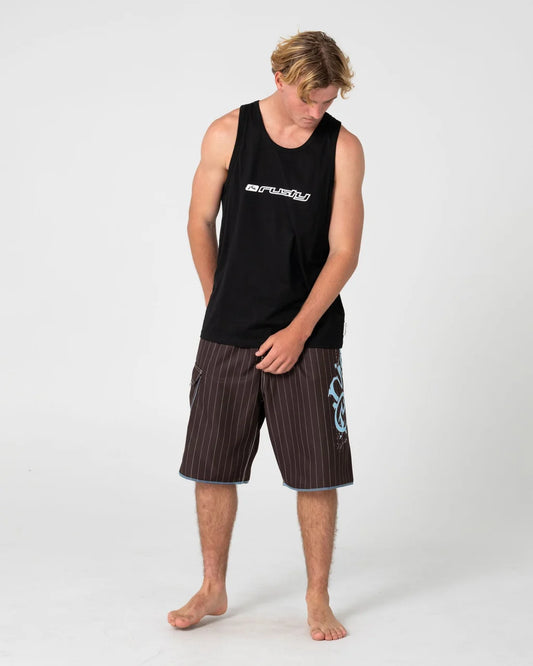 Man wearing a black tank top and striped shorts on a white background