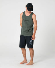 Man wearing a green tank top and black shorts with a logo on a white background