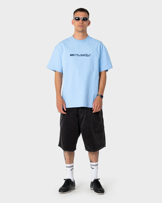 Man wearing a light blue t-shirt with a logo and black shorts on a white background