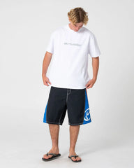Person wearing a white t-shirt and black shorts with blue accents on a white background
