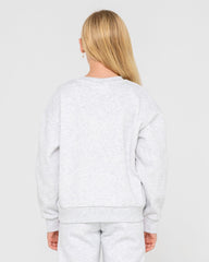 Person wearing a light gray sweatshirt and pants on a plain background