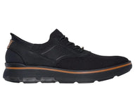 Black sneaker with brown accents on a white background