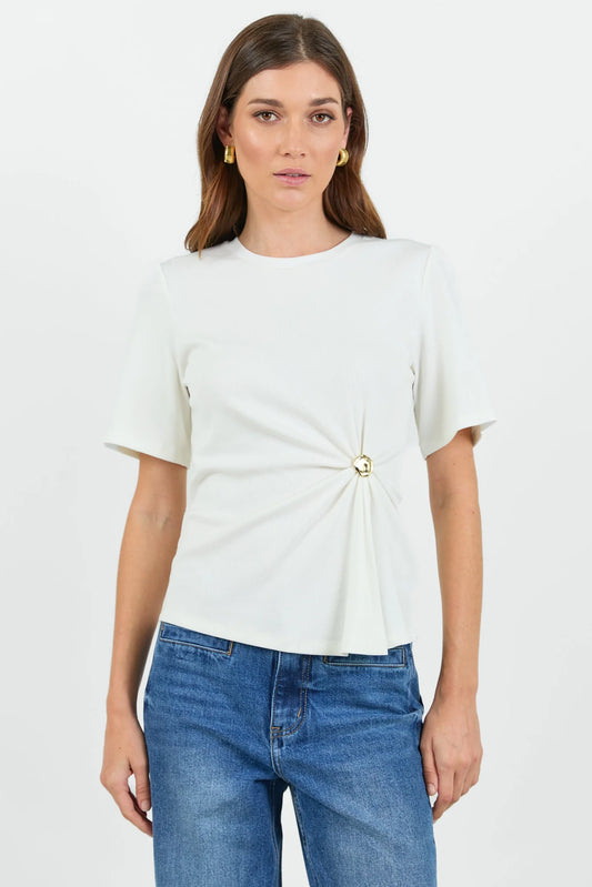 Woman wearing a white t-shirt with a knot detail and blue jeans on a white background