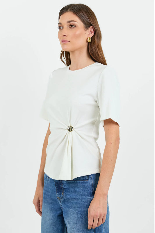 Woman wearing a white blouse with a knot detail and blue jeans on a white background