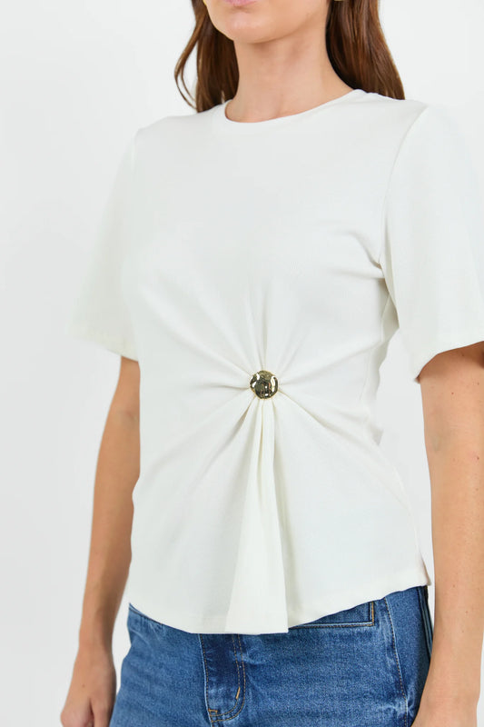 White blouse with a decorative button on a plain background