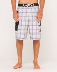 Person wearing plaid shorts with a white background