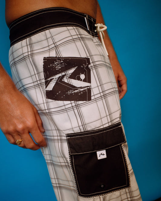 Plaid shorts with a prominent logo on a blue background