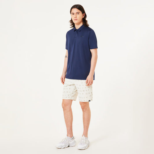 Person wearing a navy blue polo shirt and white shorts on a white background