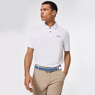 Man wearing a white polo shirt and beige pants on a light gray background