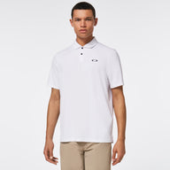 Man wearing a white polo shirt with a brand logo on a light gray background