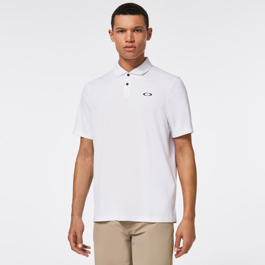 Man wearing a white polo shirt with a brand logo on a light gray background