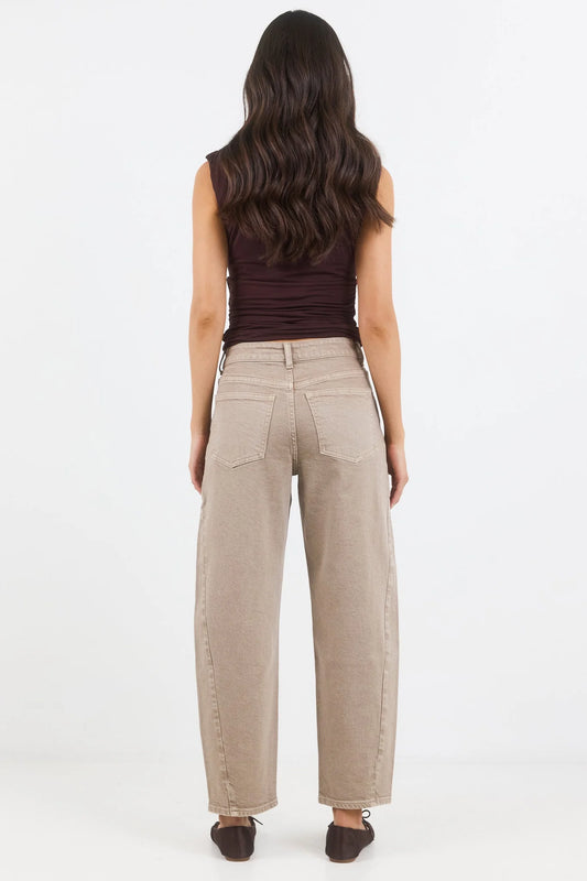 Woman wearing beige pants on a white background