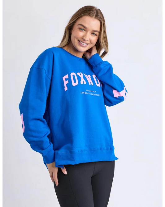 Person wearing a blue sweatshirt with 'FOXWOOD' branding on a white background
