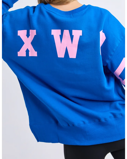 Blue sweatshirt with pink letters on a plain background