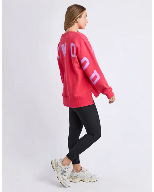 Person wearing a red sweatshirt with 'FOXWOOD' text on the back, standing against a white background