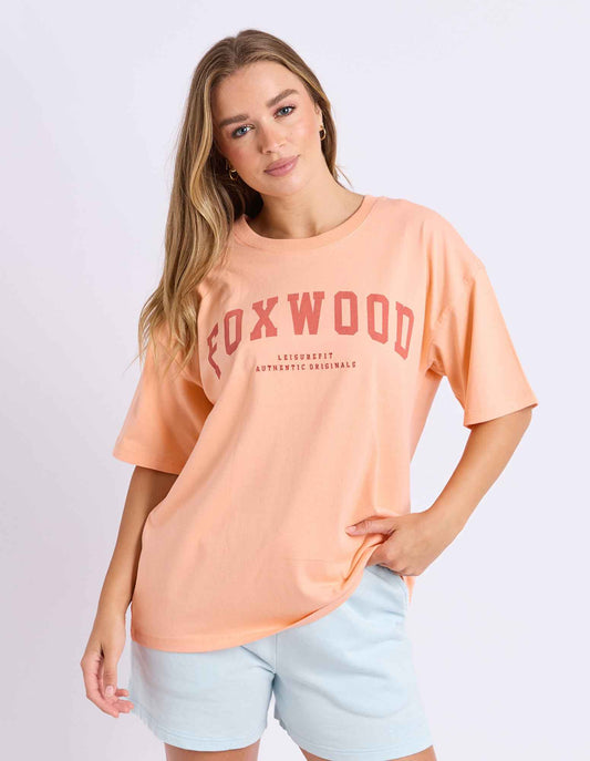 neon peach tee with pink writing and foxwood logo front and back
