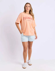 neon peach tee with pink writing and foxwood logo front and back
