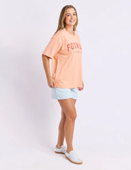 neon peach tee with pink writing and foxwood logo front and back