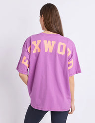 purple tee with orange writing and foxwood logo front and back