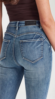 Close-up of blue jeans with a plain background