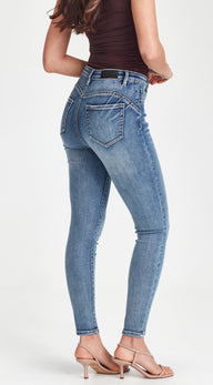 Person wearing blue jeans on a white background