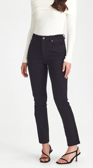 Person wearing black jeans and a white top on a white background