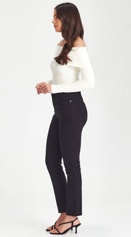 Woman wearing a white off-shoulder top and black pants on a white background