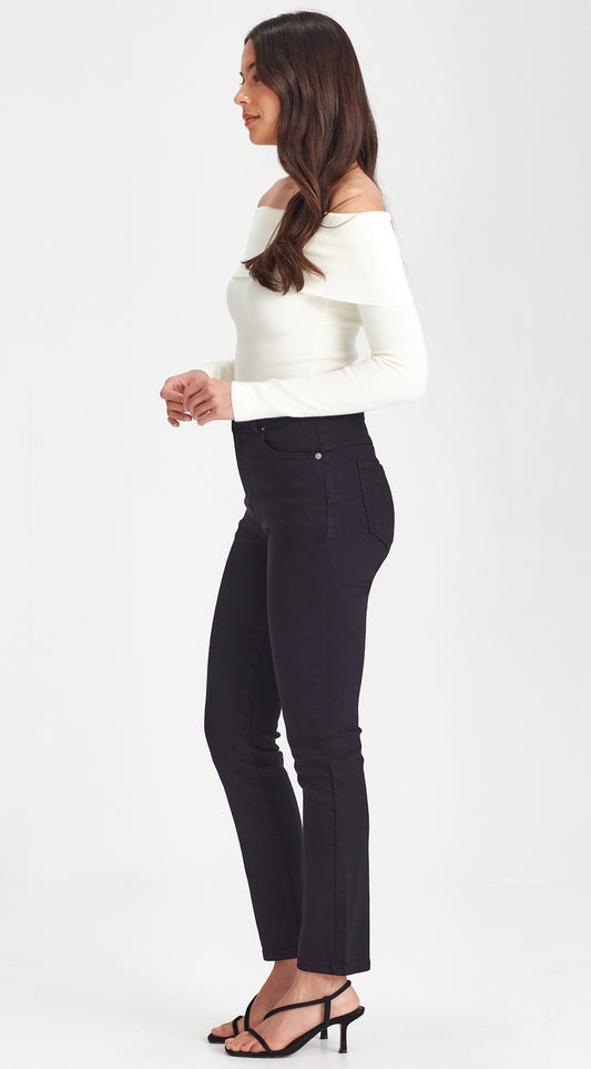 Woman wearing a white off-shoulder top and black pants on a white background