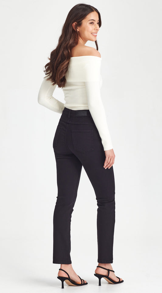 Woman wearing a white off-shoulder top and black pants on a white background