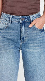 Close-up of blue jeans with a plain background